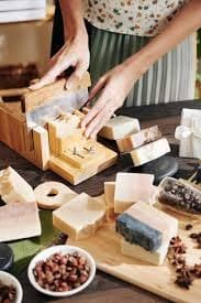 Handmade soaps curing on a wooden shelf