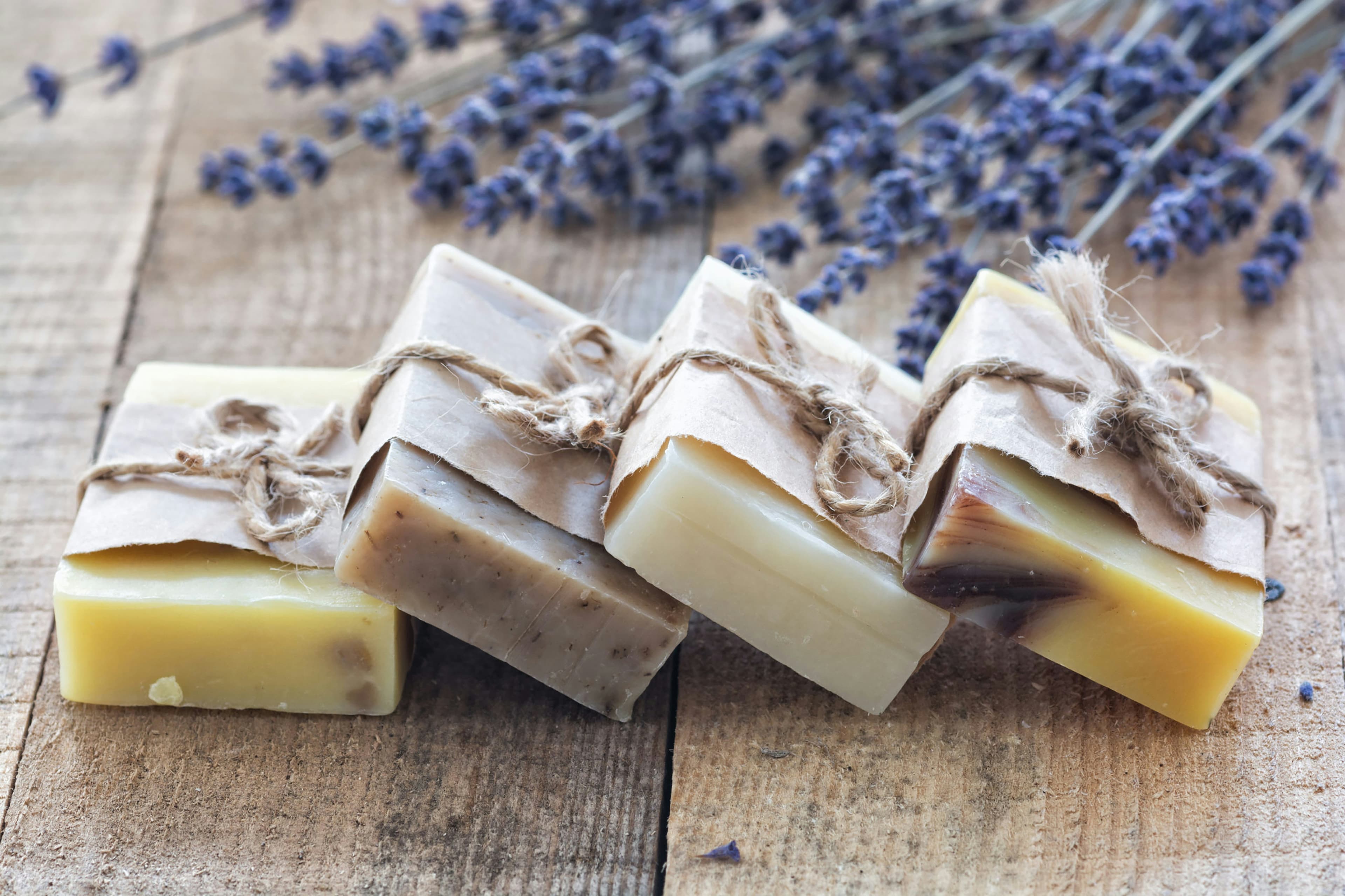 Handmade artisan soaps on a rustic wooden surface